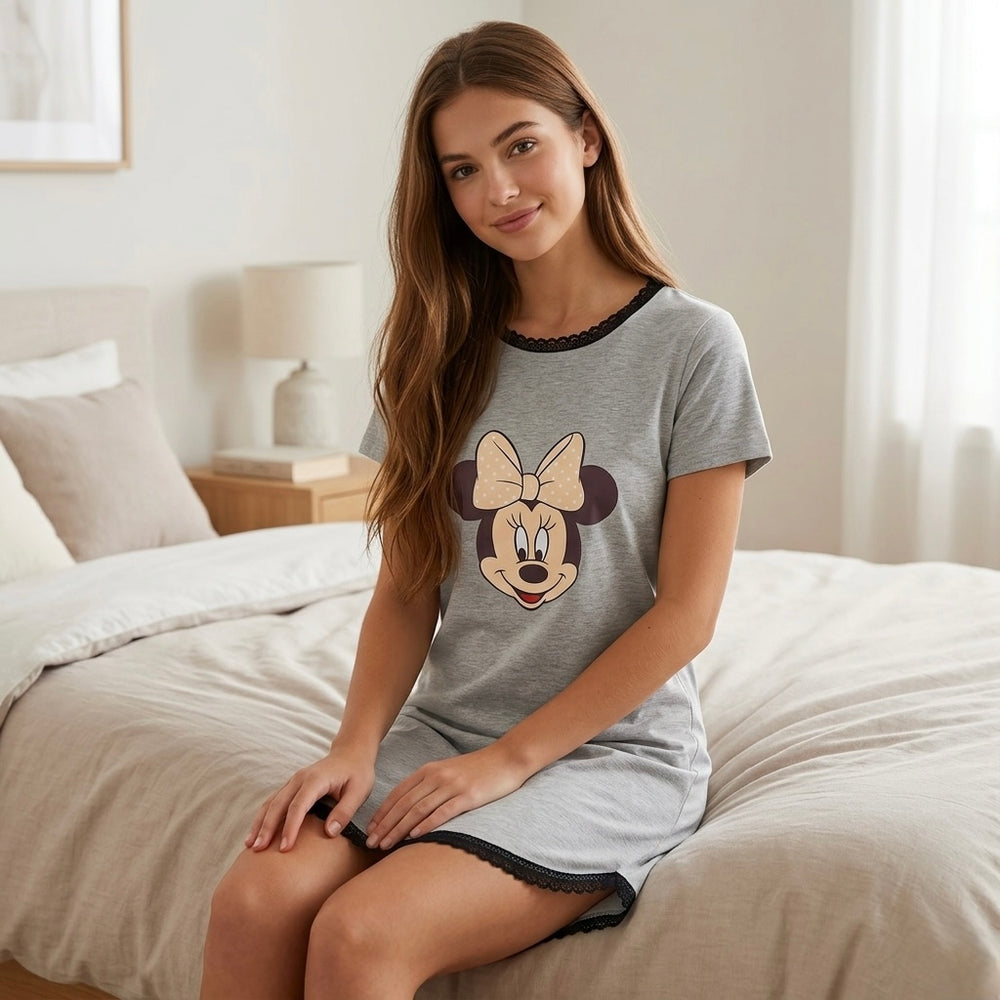 Woman wearing cotton printed night shirt relaxing on bed in cozy bedroom