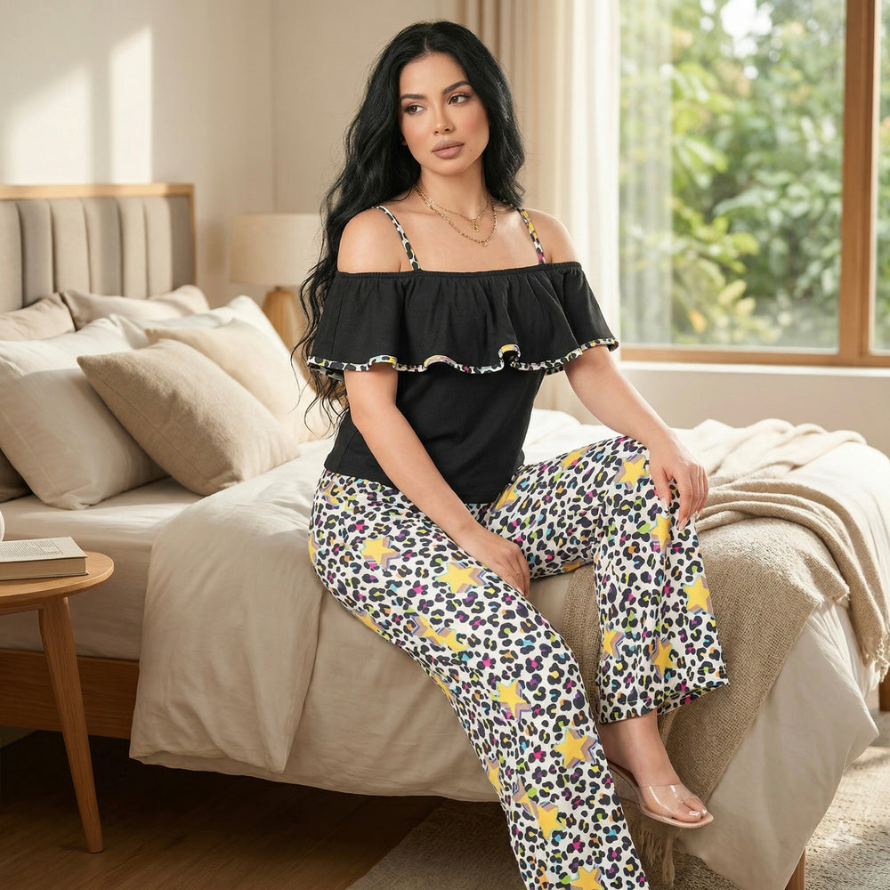 Women's cotton crop top pajama set sitting on bed printed pants